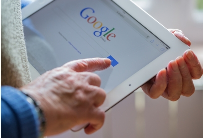 Man using tablet to Google | maximizing SEO on Gooogle